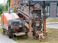 Directional drill machine, drilling technology. Horizontal directional drilling machine, HDD drill rig. Drilling rig stands on sidewalk. Trenchless installing underground utilities - pipe or cables